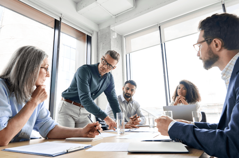 Diverse business professionals collaborating in a modern conference room meeting.